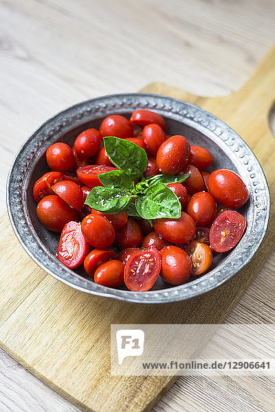Tomatoes and basil in zinc bowl