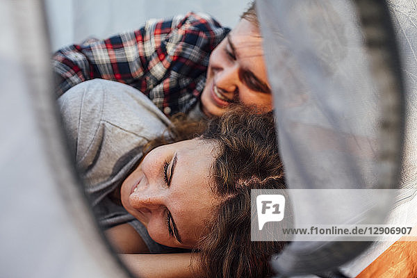 Happy couple resting in a tent