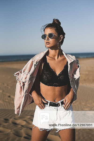 Portrait of fashionable teenage girl on the beach