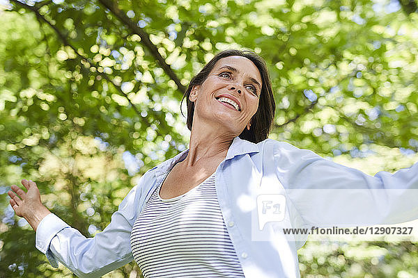 Portrait of relaxed mature woman dancing in nature