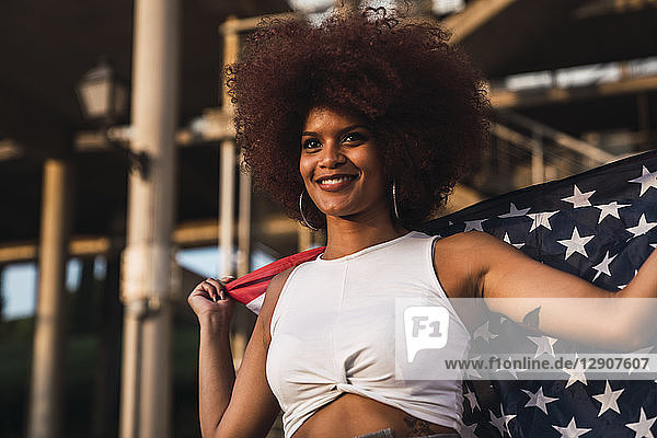 Portrait of smiling young woman with American flag