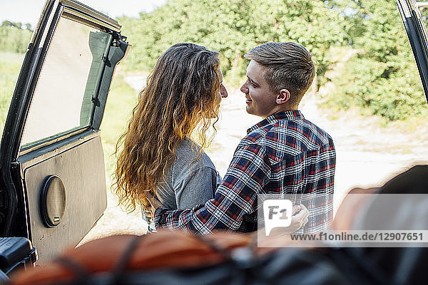 Romantic couple doing road trip  embracing