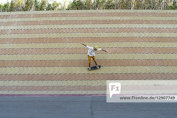Young man riding skateboard on a wall
