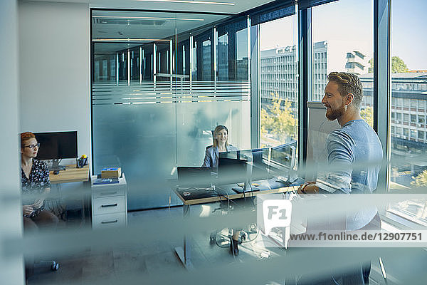 Smiling man leading a presentation in office