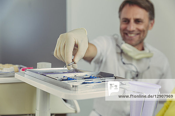 Dentist using dental instruments for treatment