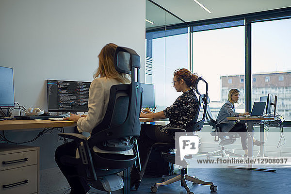 Businesswomen using computers in office