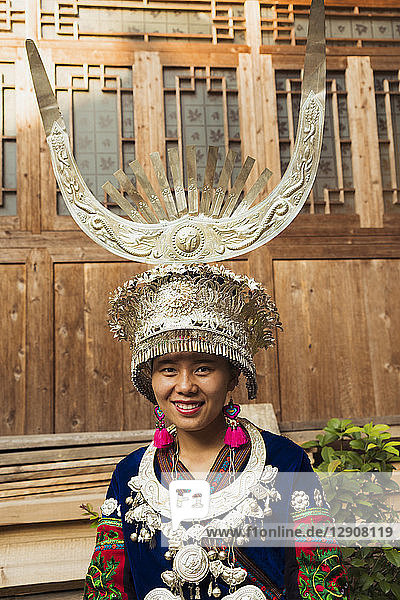 China  Guizhou  portrait of a young Miao woman wearing traditional dress and headdress