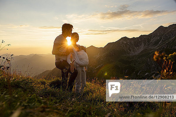 Germany  Bavaria  Oberstdorf  family with little daughter on a hike in the mountains at sunset