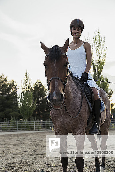 Smiling woman siiting on horse