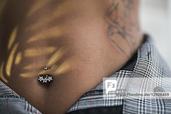 Woman with navel piercing  close-up