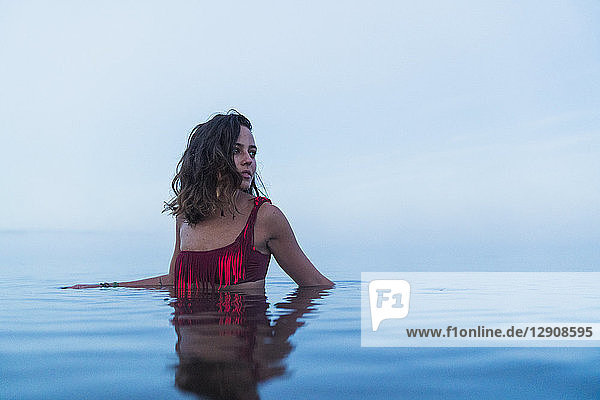 Woman wearing bikini  standing in water of a lake