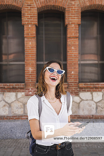 Young woman sight seeing in Madrid  using smartphone
