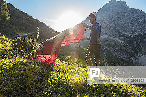Austria  Tyrol  Hiker setting up his tent in the mountains