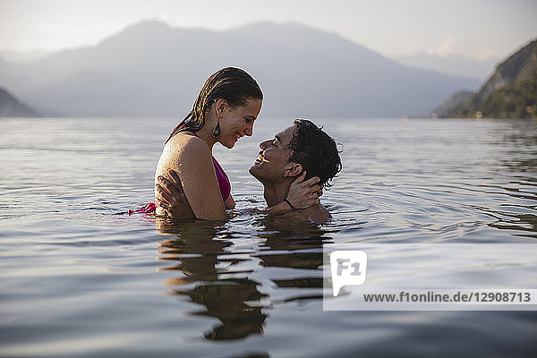 Happy affectionate young couple in a lake