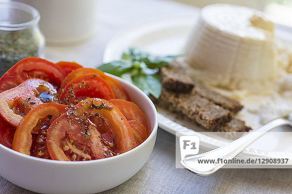 Bowl of sliced tomatoes flavoured with oregano