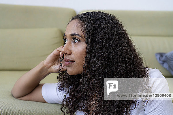 Young woman sitting at home  thinking