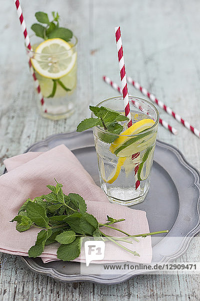 Glasses of infused water with lemon  lime and mint