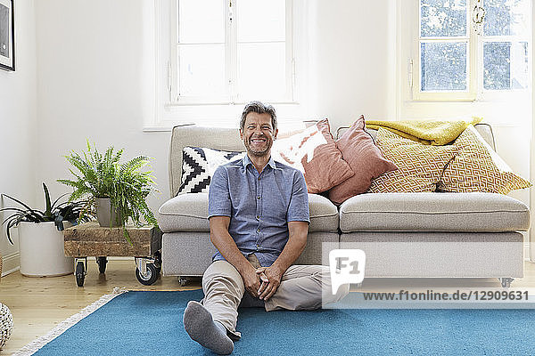 Man sitting at home  looking happy