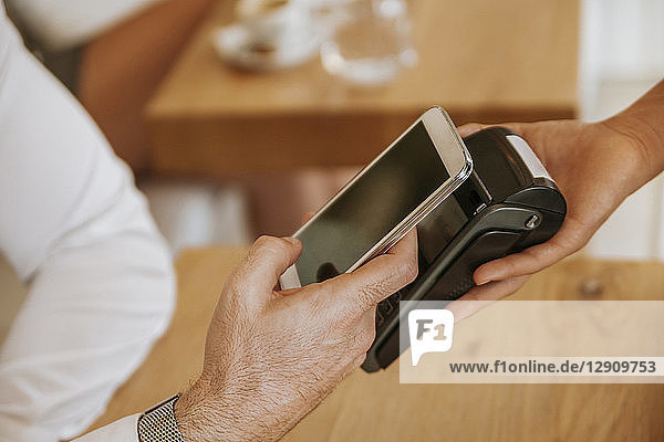 Contactless payment with smartphone in cafe