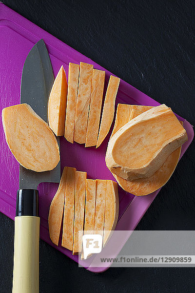 Sliced and sweet potato on chopping board