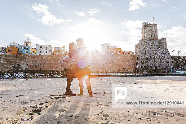 Italy  Molise  Termoli  young couple in the beach at sunrise