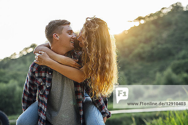 Romantic couple spending time in nature  kissing at sunset