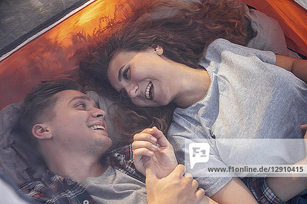 Happy couple resting in a tent