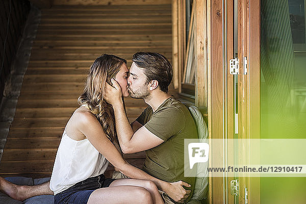 Affectionate couple kissing on balcony