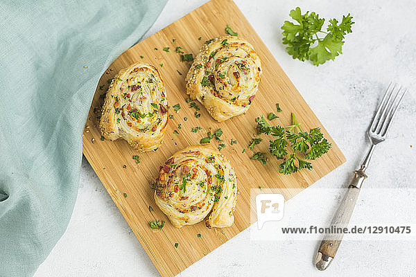 Sticky buns with feta  cream cheese  bacon and parsley on wooden board