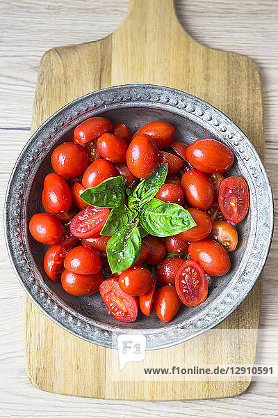Tomatoes and basil in zinc bowl  overhead view