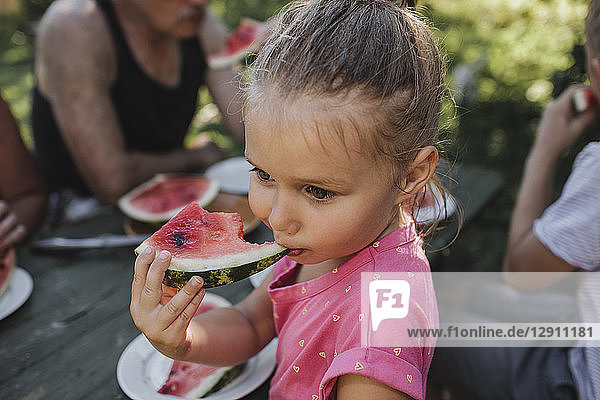 Portrait of little girl eating watermelon