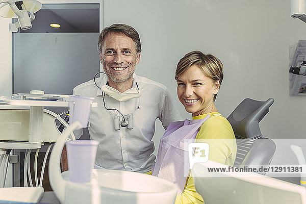 Dentist and patient smiling at camera  portrait