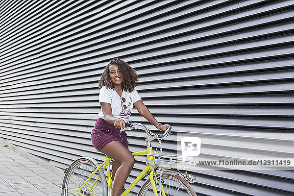 Portrait of smiling young woman riding bicycle