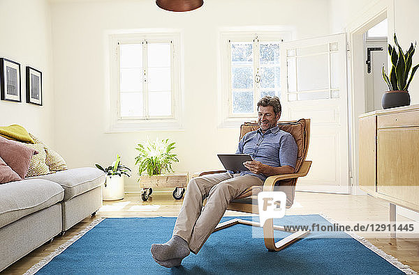 Man working at home using digital tablet