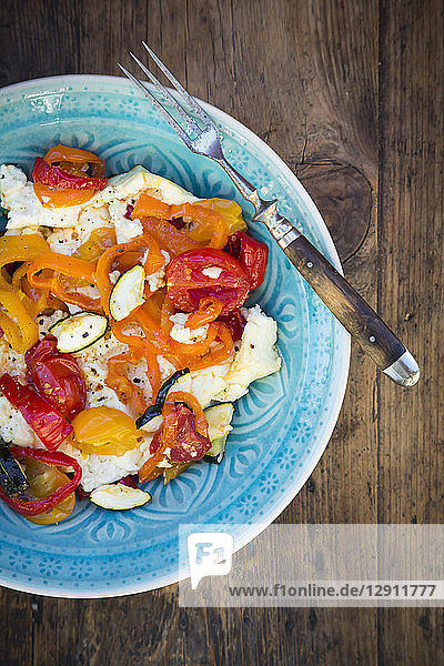 Baked goat cheese with paprika  tomato and zucchini