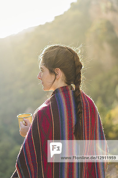 Spain  Alquezar  woman with braid and coffee mug at backlight