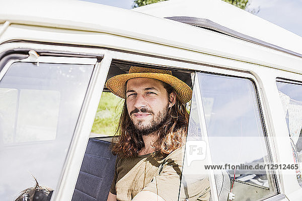 Portrait of young man in a van