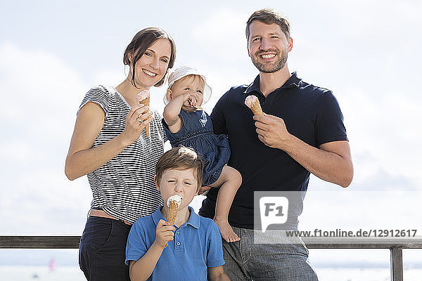 Happy family with two children eating ice cream
