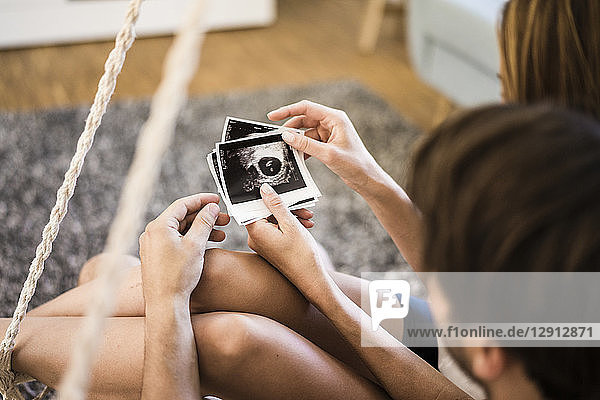 Couple looking at ultrasound scans