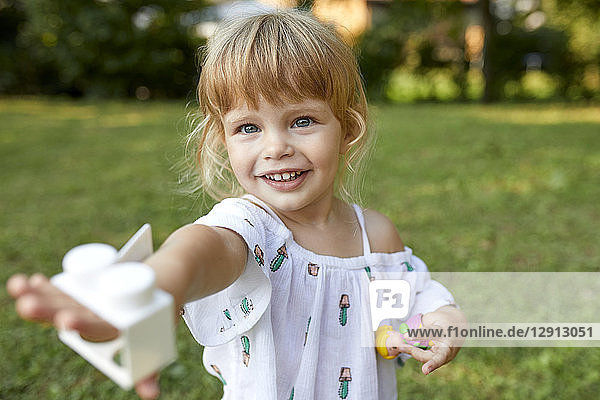 Portrait of cute little girl in garden