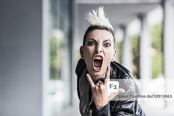 Portrait of screaming punk woman at an arcade