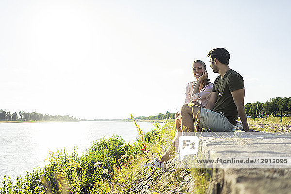 Couple relaxing at the riverside in summer