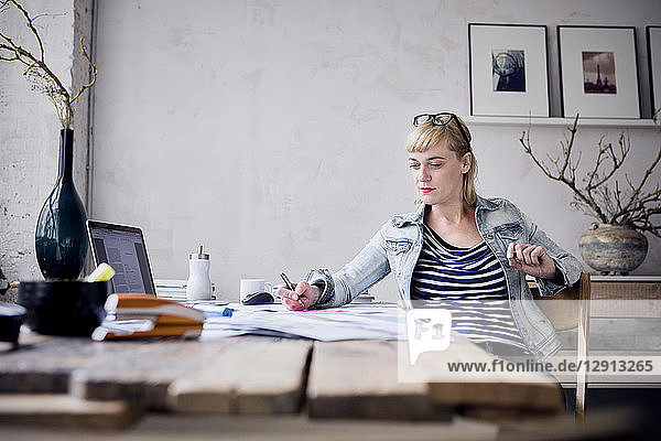 Woman working at desk in a loft