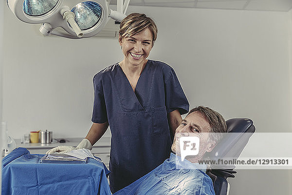 Dental surgeon talking to patient before treatment