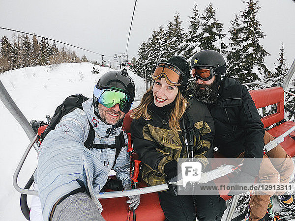 Italy  Modena  Cimone  portrait of happy friends in a ski lift