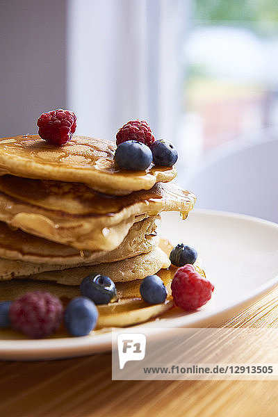 Pile on pancakes on plate with berries