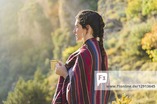 Spain  Alquezar  young woman with coffee mug in nature