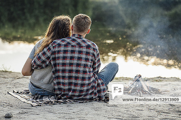 Romantic couple sitting at the riverside