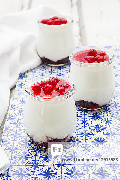 Greek yogurt with red currant sauce on blue patterned tiles
