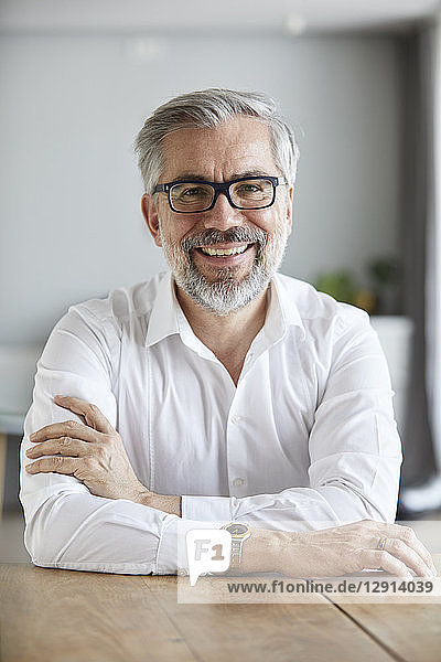 Portrait of smiling mature man at home